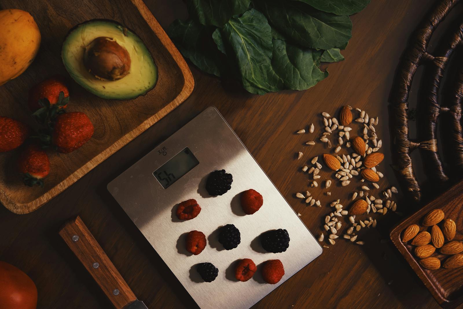Chef weighing ingredients on a digital scale for recipe costing — calculating per-portion ingredient cost